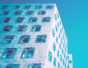 Low angle view of modern building against clear blue sky