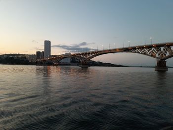 Bridge over river with city in background