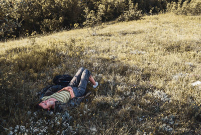 Side view of boy lying on field
