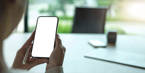 Midsection of man using laptop on table