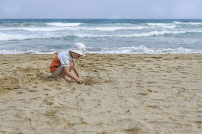 Full length of man on beach against sky