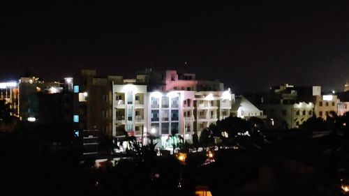 View of town against sky at night