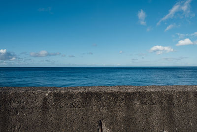 Scenic view of sea against blue sky