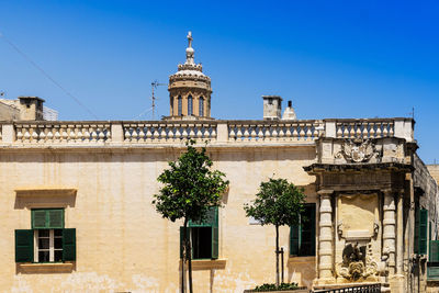 Low angle view of building against blue sky