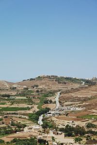 Aerial view of landscape against clear blue sky