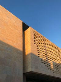 Low angle view of building against clear blue sky