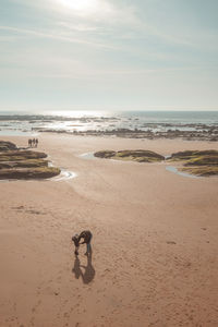 Scenic view of beach against sky during sunset
