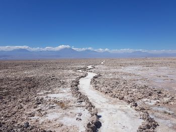 Scenic view of walkway in desert against sky