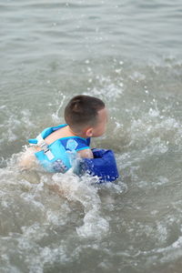 High angle view of boy in sea