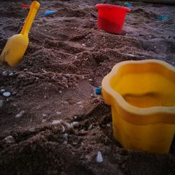 Close-up of yellow umbrella on sand