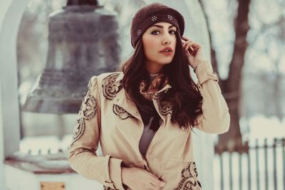 Portrait of beautiful young woman standing outdoors