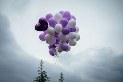 Low angle view of balloons against sky