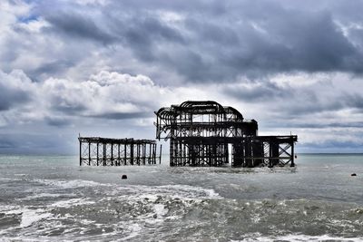 Lifeguard hut on beach against sky