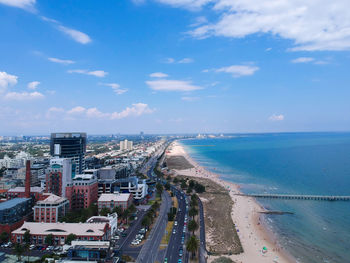 High angle view of buildings by sea against sky