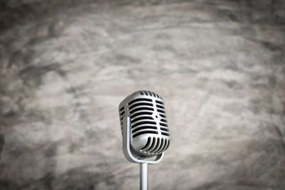Close-up of microphone against wall