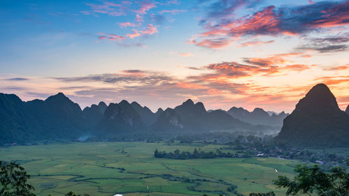 Scenic view of mountains against sky at sunset