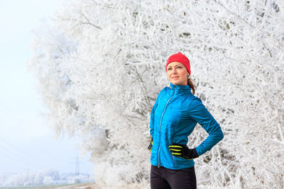 Portrait of woman standing in snow