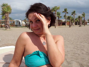 Close-up portrait of mature woman smiling at beach