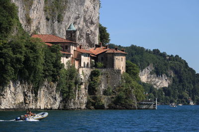 Scenic view of sea by buildings against sky