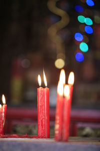 Close-up of lit candles in temple