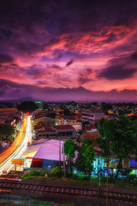 High angle view of illuminated buildings against sky at sunset