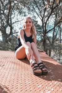 Portrait of a smiling young woman sitting outdoors