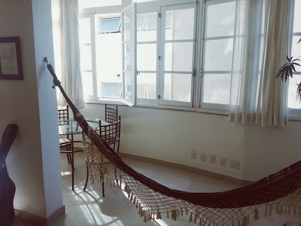 indoors, window, architecture, built structure, home interior, house, glass - material, chair, building exterior, railing, sunlight, curtain, absence, building, day, no people, balcony, steps, staircase, empty