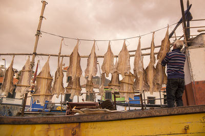 Low angle view of clothes drying against sky