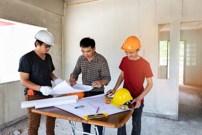 Side view of man working at construction site