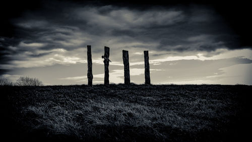 Hay bales on field against sky