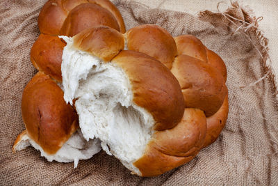 Challah or braided bread on rustic surface