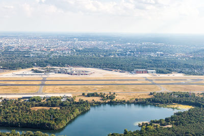 High angle view of river amidst city against sky