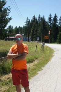 Rear view of man walking on road against sky