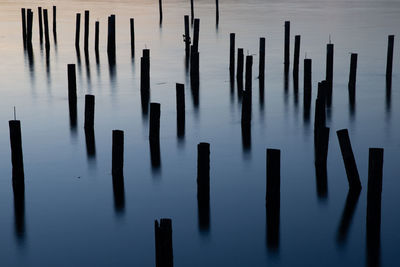 High angle view of wooden posts sea