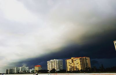 Low angle view of buildings against storm clouds