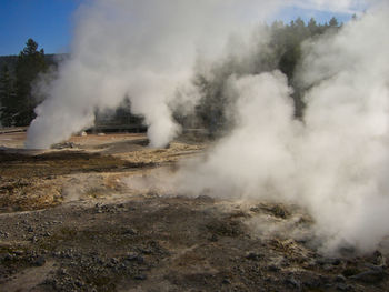 Smoke emitting from volcanic mountain against sky