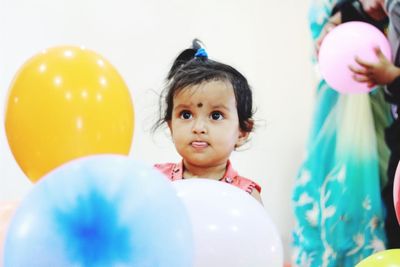 Portrait of a girl looking at balloons