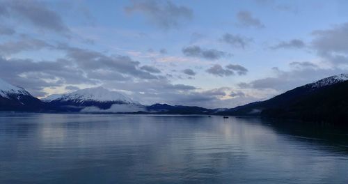 Scenic view of lake and snowcapped mountains against sky