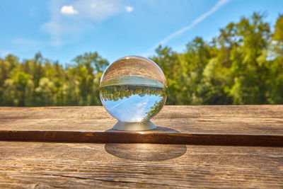 Close-up of crystal ball on wooden table