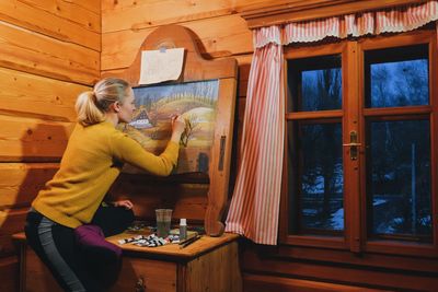 Woman standing by window