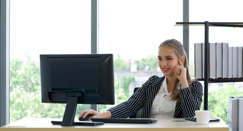 Man working with smart phone sitting on table
