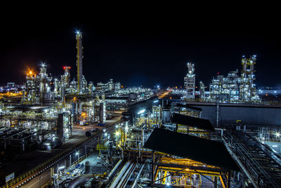 High angle view of illuminated buildings against sky at night