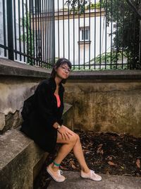 Portrait of young woman sitting outdoors