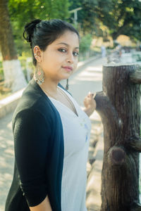 Portrait of young woman standing outdoors