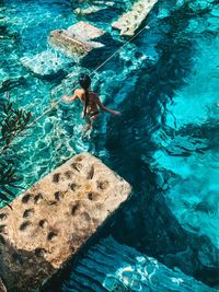 High angle view of man swimming in sea