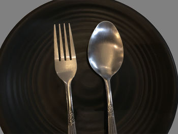 Low angle view of metal spoon and fork
