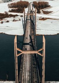 Bridge over lake against sky during winter