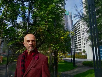 Portrait of young man standing in city