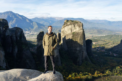 Man standing on rock against mountains