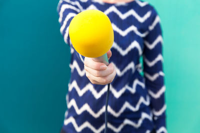 Close-up of human hand against blue background